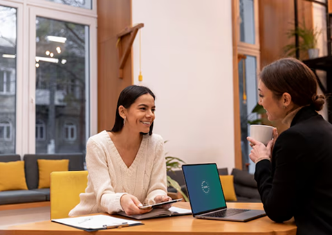 Two professionals at Forever Young collaborating in the office, providing expert wealth management services to clients in Palm Beach Gardens, helping secure their financial futures.